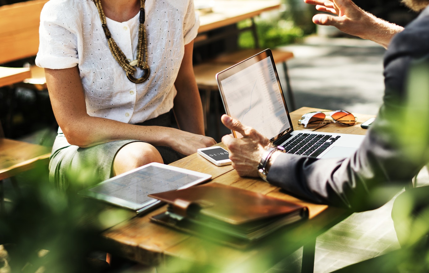 Image of people working on a budget together, to get out of debt, showing the benefits of hiring a financial coach in Minneapolis 